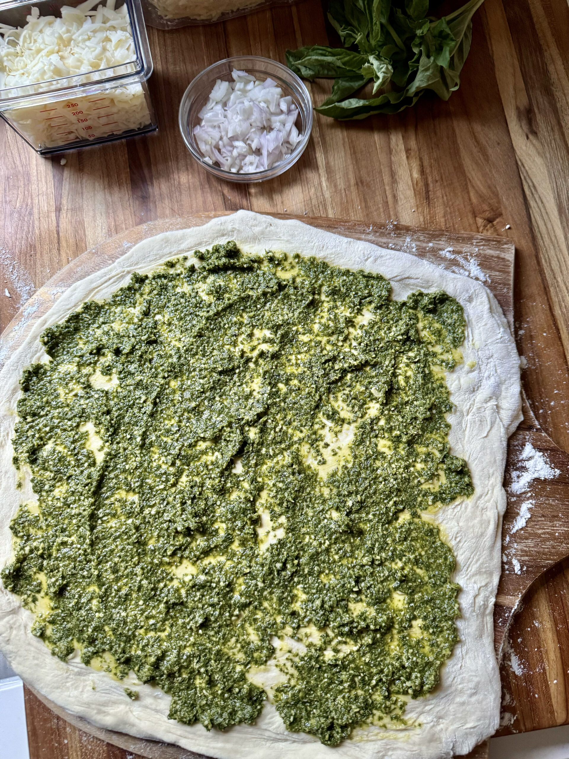 spread pesto on dough