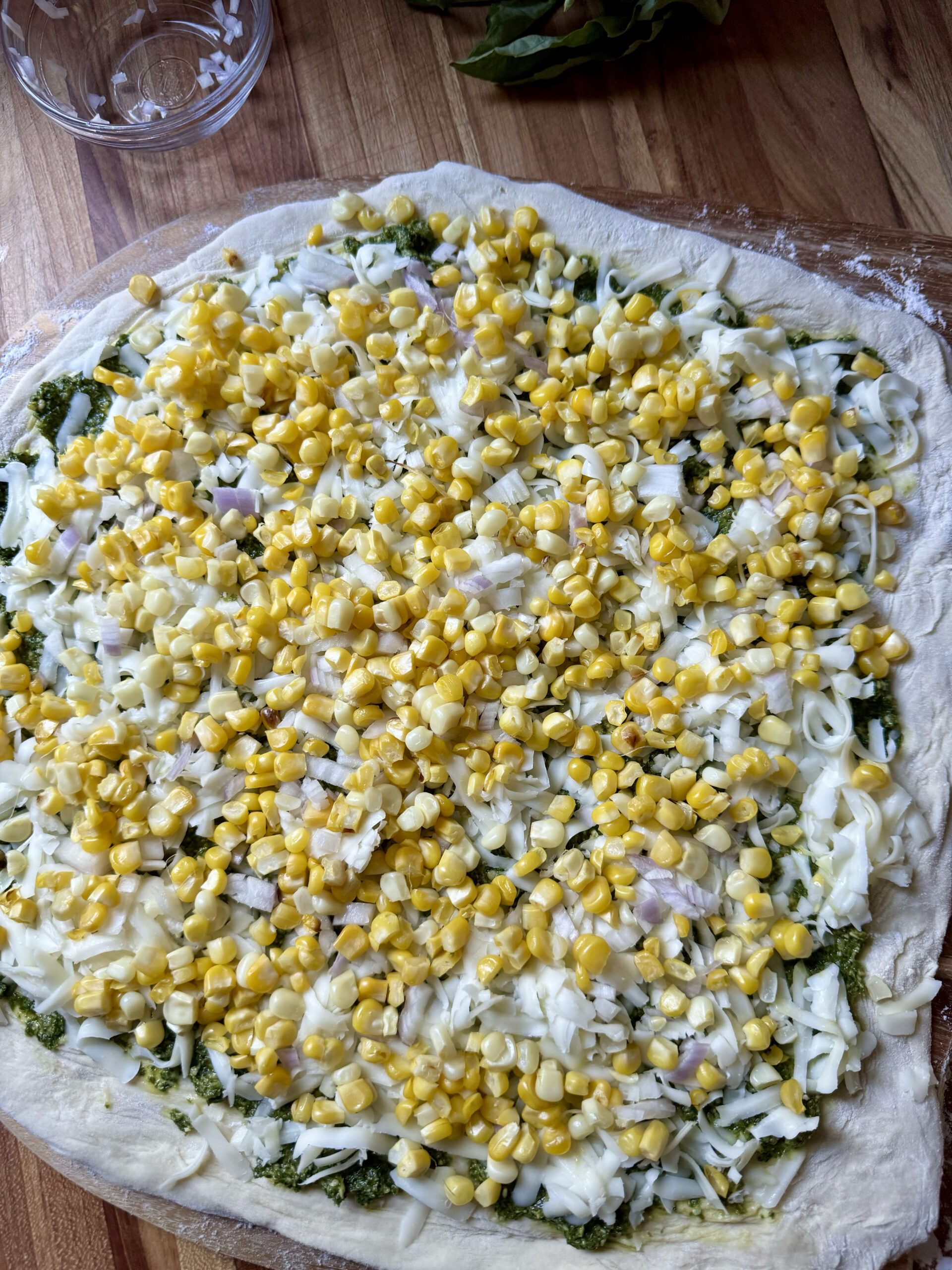 sprinkle corn on pizza