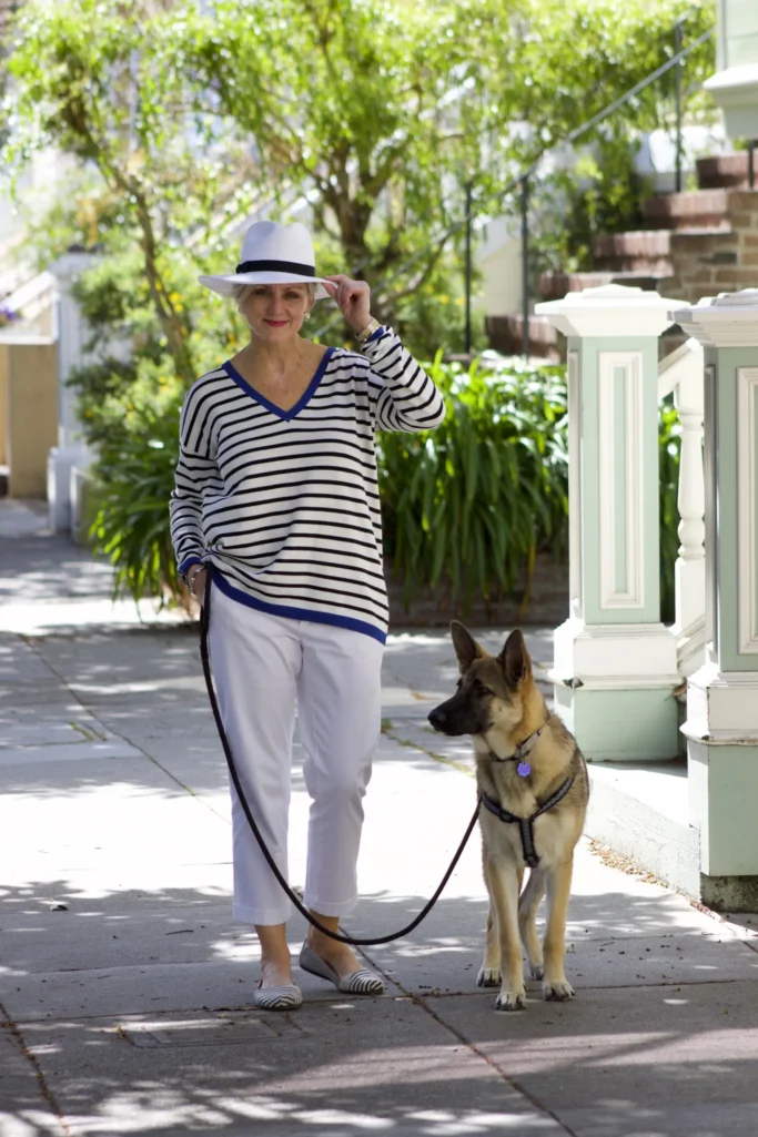 Beth wearing striped tunic and white pants with Oscar the German Shepherd on city sidewalk - Fridays with Oscar February 2015