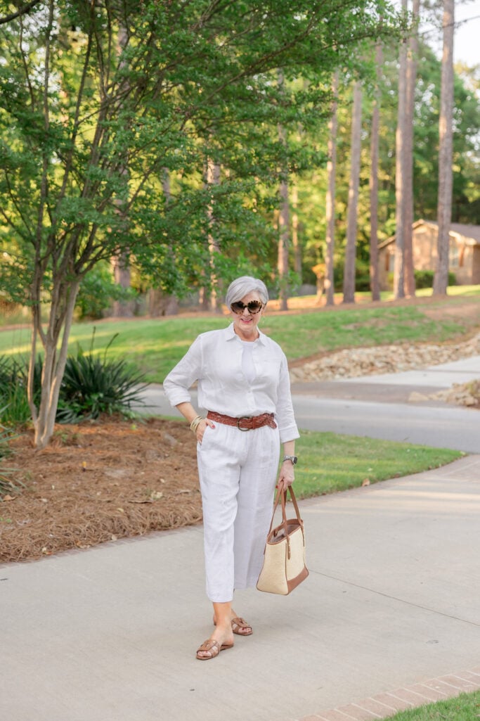Beth Djalali wearing a white linen button up, white tee, and white linen pants