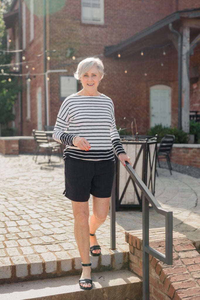  Beth Djalali wearing a striped top and black shorts – summer outfit idea for women over 60