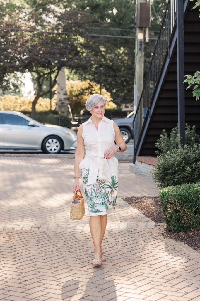 Sleeveless summer dress paired with a raffia clutch and clear sandals for a simple, chic one-piece outfit.