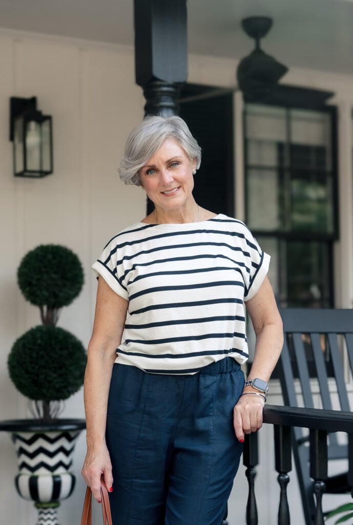 Woman over 50 wearing a boxy striped J.Jill tee and navy pants