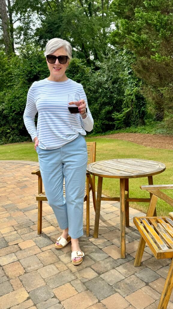 Beth Djalali wears a blue and white striped tee with khaki chinos and sandals—a casual summer outfit formula for women over 50