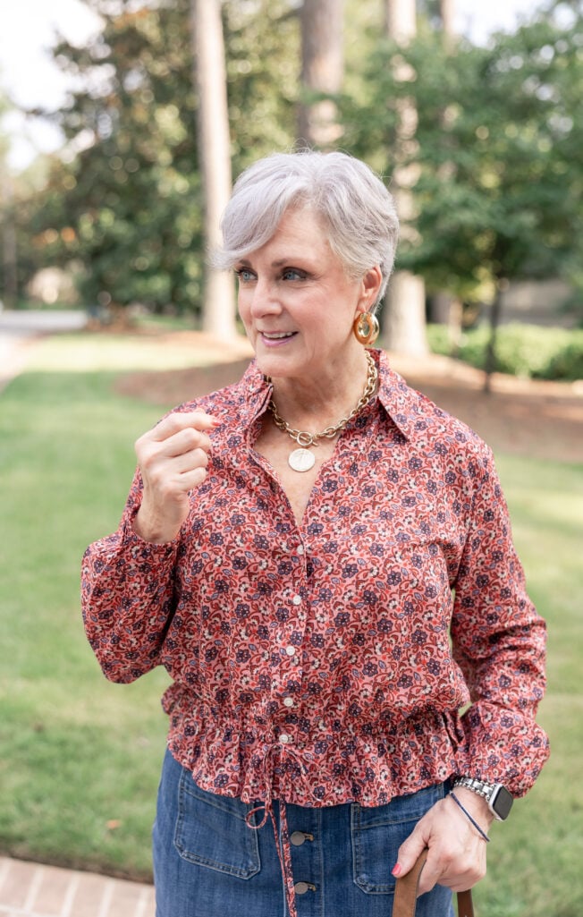 Beth Djalali wearing a printed fall blouse and denim skirt, a transitional summer-to-fall outfit
