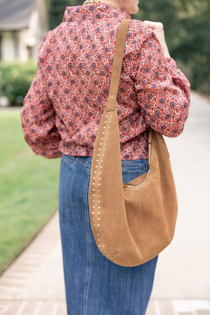 Close-up of Beth Djalali’s suede slingbacks and camel tote styled for summer-to-fall transition.