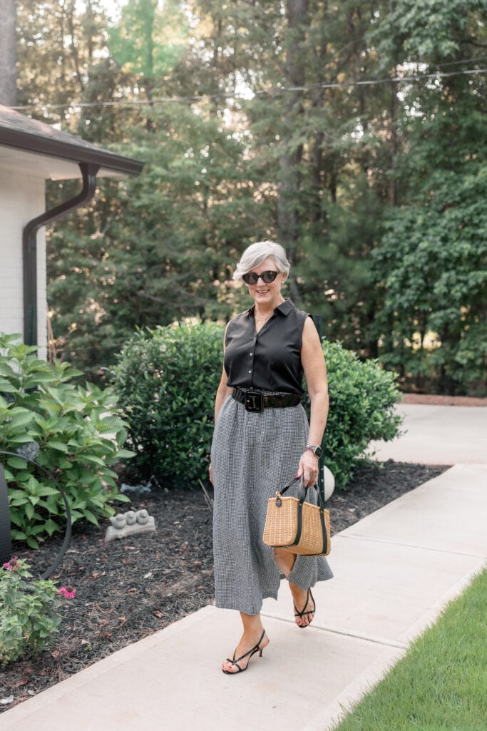 Neutral summer outfit with texture: black blouse, gingham skirt, woven tote