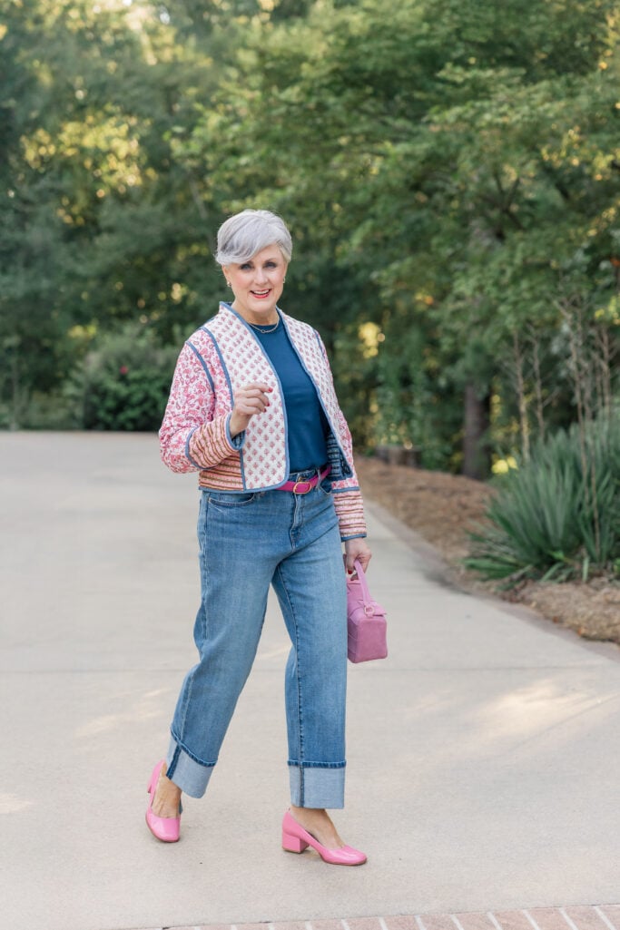 Beth Djalali wearing patterned quilted jacket with cuffed jeans and pink block heels