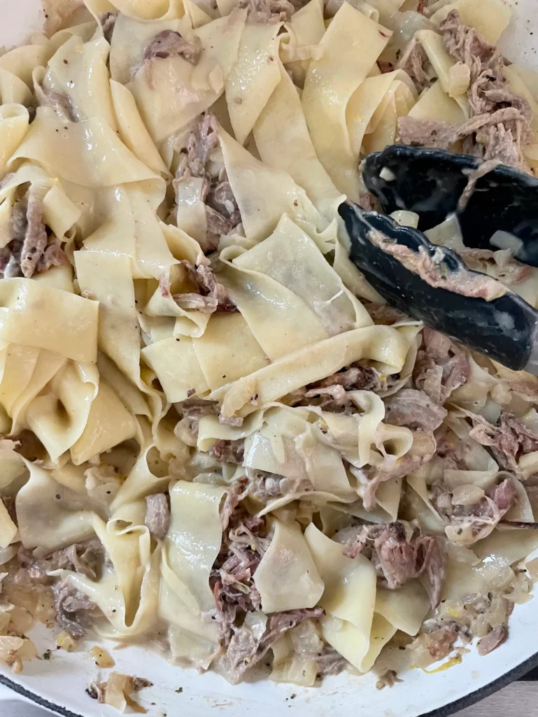 Stirring the noodles and the ragu
