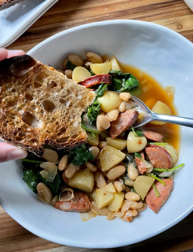Brothy Beans with Sausage, Potatoes served with bread