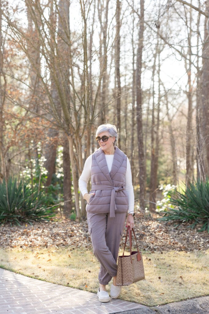 Beth Djalali in cream lounge set at home with sneakers — cozy, elevated loungewear for mature women.