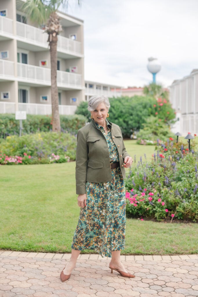 Beth Djalali styling a green utility jacket with printed dress  for a modern fall look.