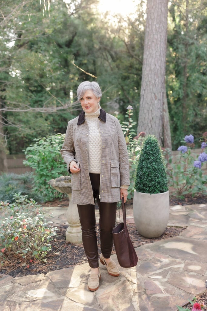 Beth Djalali wearing field jacket, cable-knit sweater, and brown leggings in countryside-inspired fall fashion.
