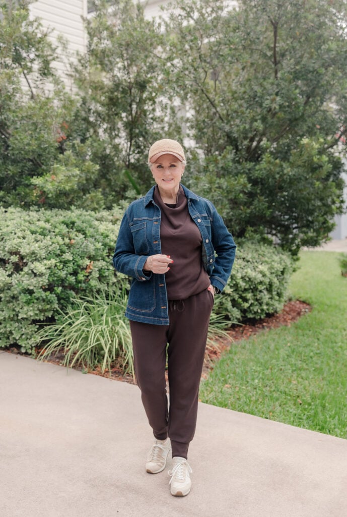 Woman wearing a deep indigo field jacket over an athleisure matching set.