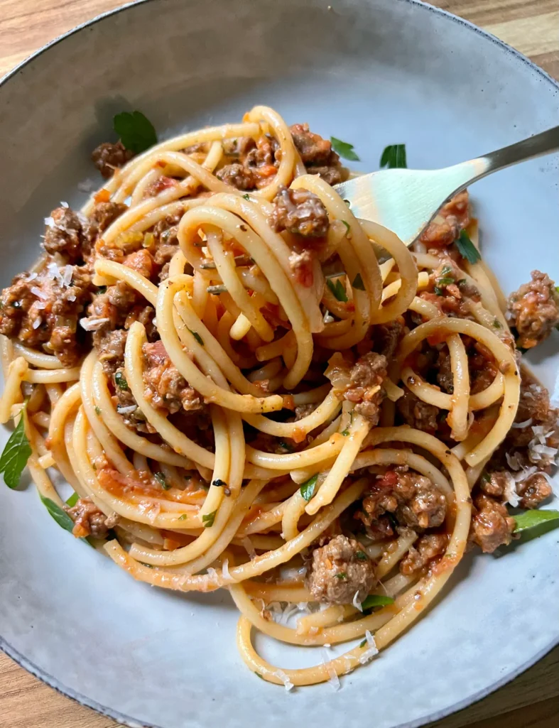 a forkful of Lamb Bolognese with Bucatini