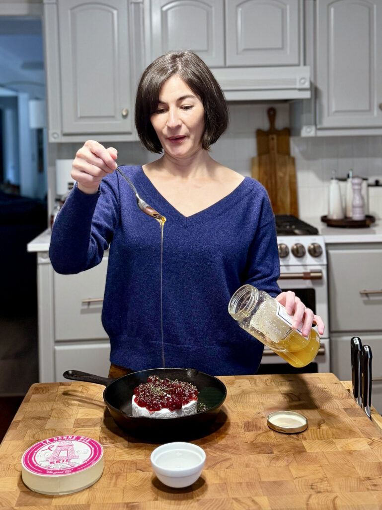woman preparing baked brie appetizer