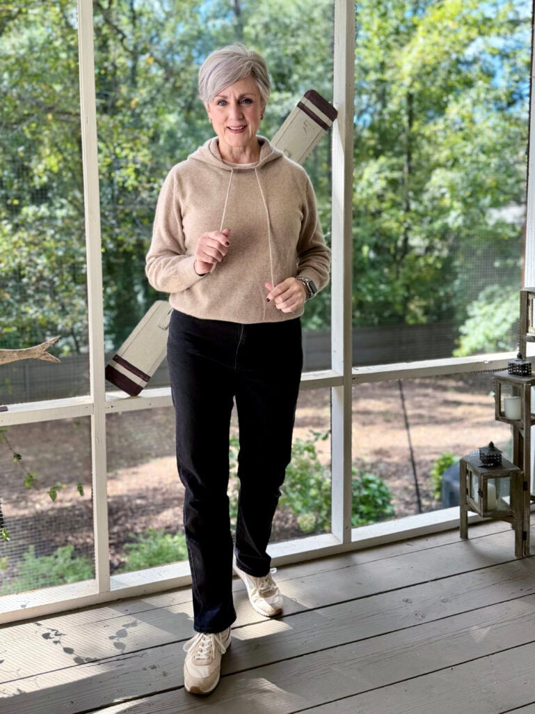 woman over 50 wearing black jeans and sneakers
