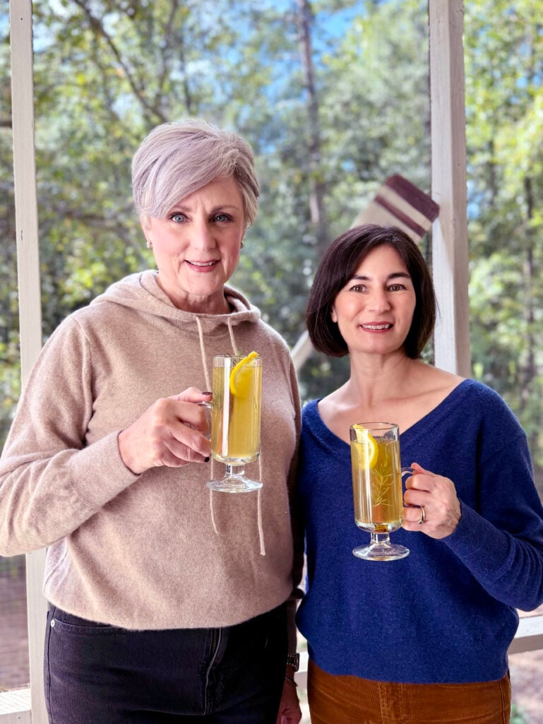Two women wearing cashmere sweaters and fall neutrals
