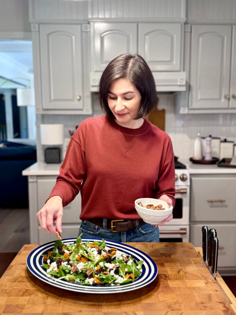 Kelly preparing the roasted sweet potato and arugula salad