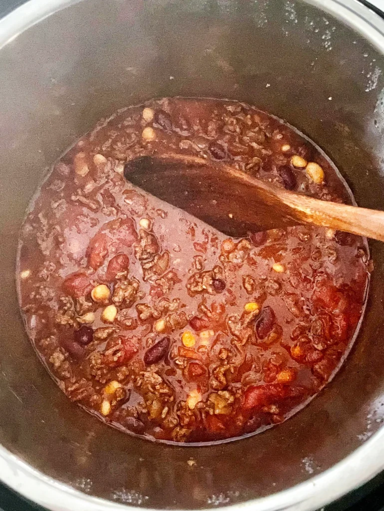 Simmering the instant pot chili to thicken.