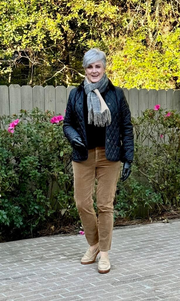 Beth Djalali in navy quilted jacket, plaid scarf, and camel cords for polished equestrian chic.
