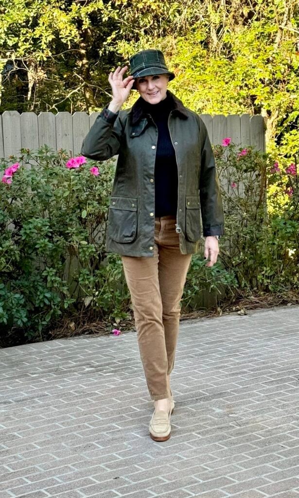 Beth Djalali wearing a waxed green jacket and plaid hat for heritage fashion 2025 inspired by royal countryside style.
