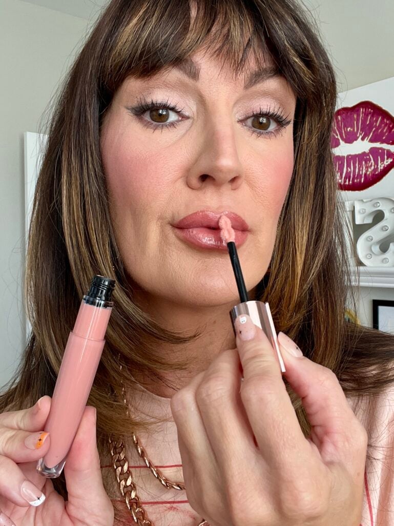woman applying lip glss