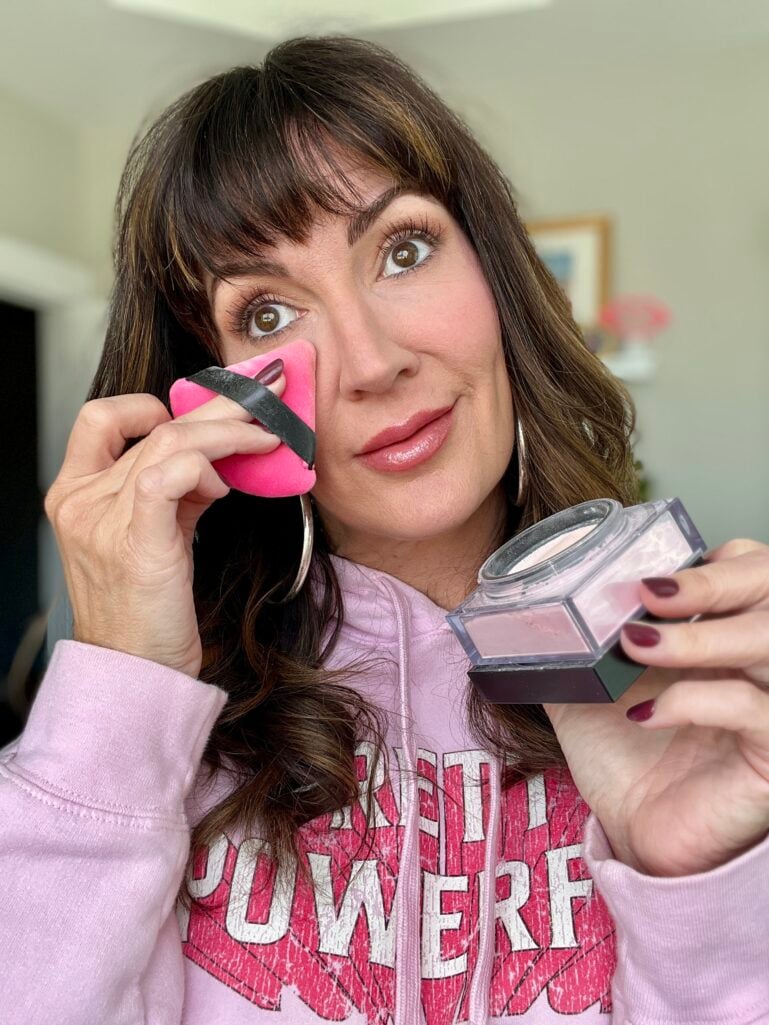 Jennifer demonstrates setting her makeup with powder and a puff.