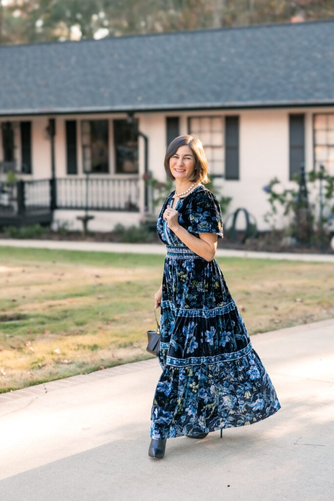 Kelly walking in navy floral velvet maxi dress showing movement and flow - petite formal dress styling