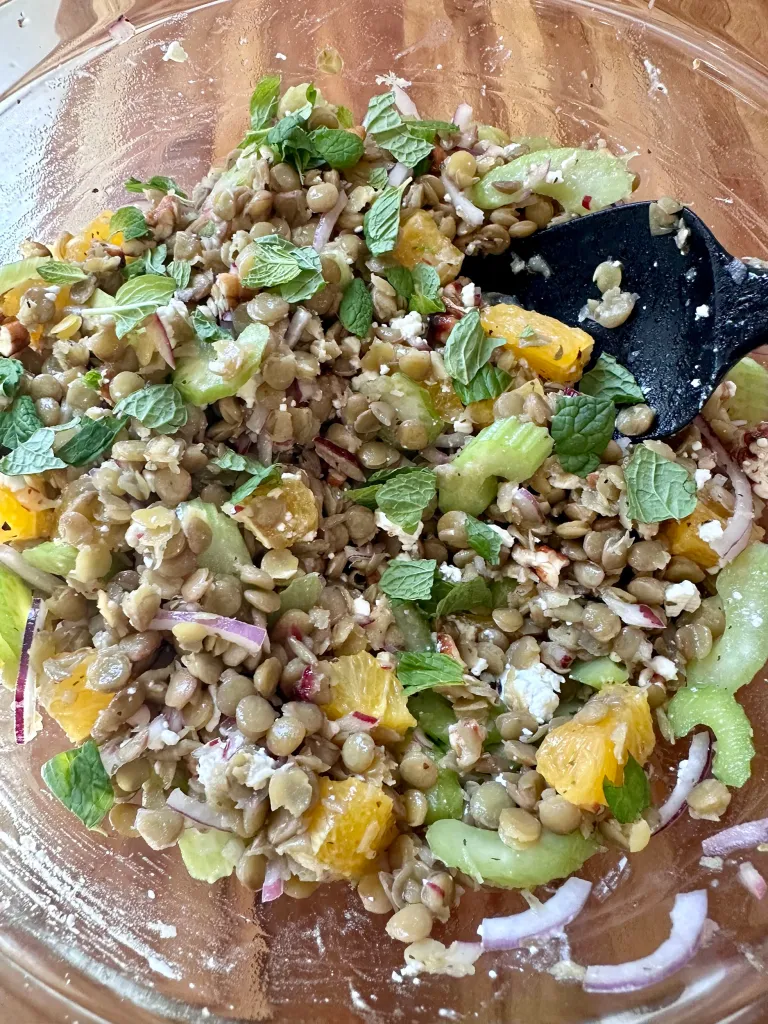 Lentil salad in glass bowl tossed with fresh mint and feta cheese - Mediterranean lentil salad recipe