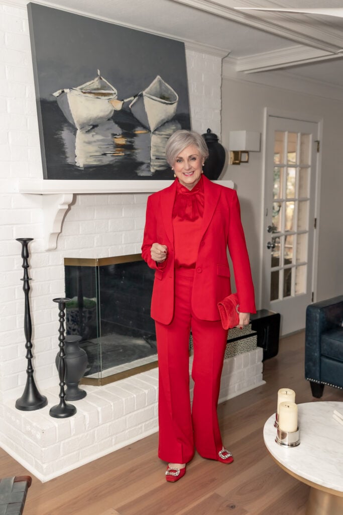 red monochromatic suit outfit for women over 50, bold holiday fashion with satin blouse and tailored blazer