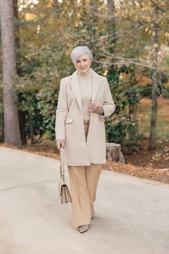 woman over 50 wearing camel monochromatic outfit with wool coat and cream turtleneck, winter style in Athens Georgia