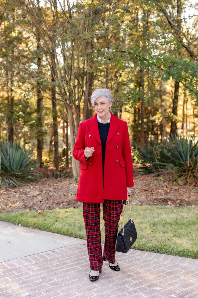 style rules women over 50 — chic fall outfit with red coat and plaid pants for confident classic style