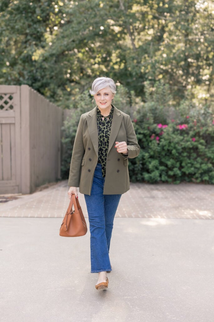 woman over 50 olive blazer leopard blouse and jeans neutrals with personality