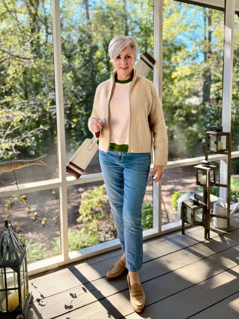 Beth’s cozy fall look featuring a beige zip cardigan layered over a light sweater with jeans and loafers, styled for a relaxed weekend.