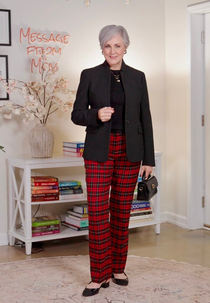 Beth Djalali wearing red plaid trousers and black blazer — bold red accents for women over 50, fall 2025 color trends, classic red outfit inspiration