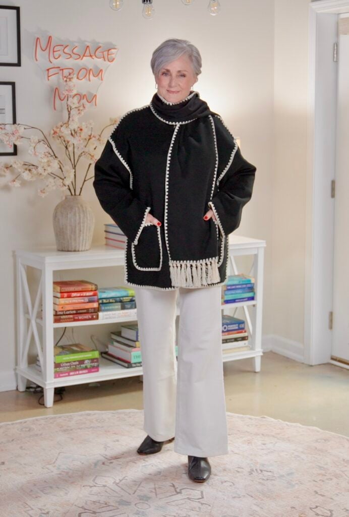 Winter outfit with black contrast-trim jacket, cream wide-leg trousers, and black Chelsea boots.