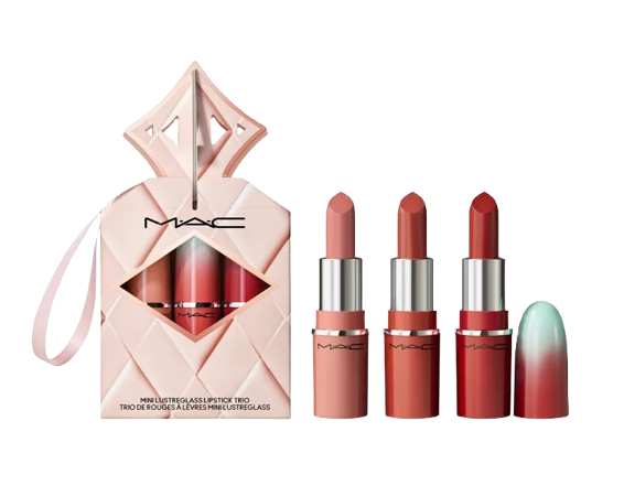 MAC Mini Lustreglass Lipstick Trio in assorted nude shades, displayed with three small lipsticks in gradient pink packaging beside a quilted blush gift box with a ribbon loop.