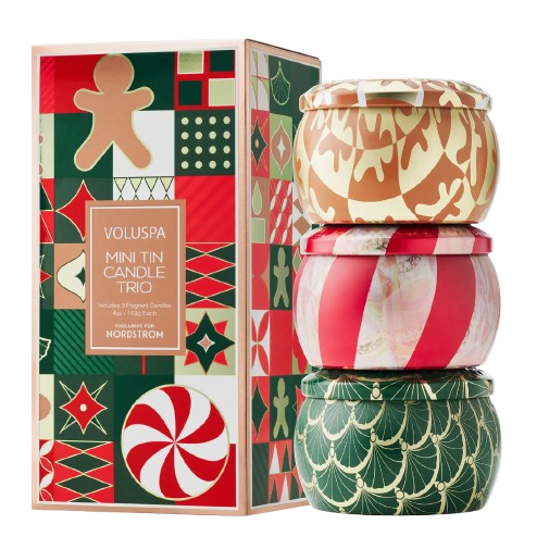 Voluspa Mini Tin Candle Trio holiday set, featuring three patterned tins stacked together—gold and cream, red and pink striped, and green with gold scallops—next to a festive gift box in red, green, and gold.