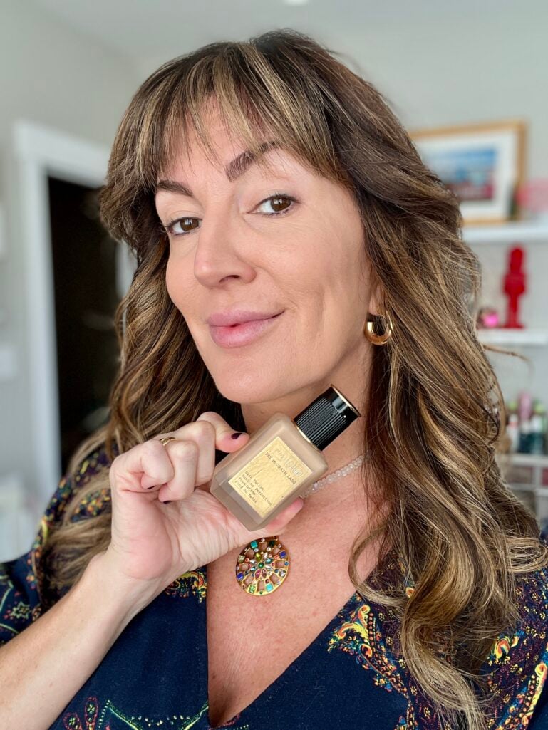 Woman displaying Pat McGrath Labs Skin Fetish Sublime Perfection Foundation in light medium shade, wearing minimal makeup look
