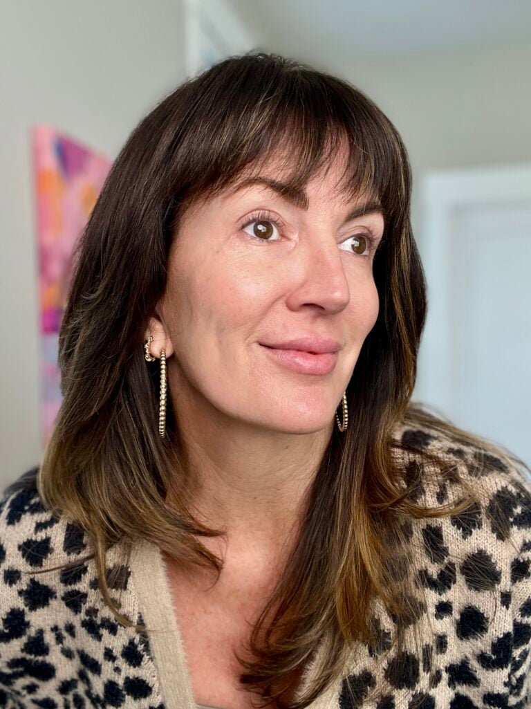 Jennifer after completing 7-step skincare routine with glowing smooth skin in leopard cardigan - skincare results over 40