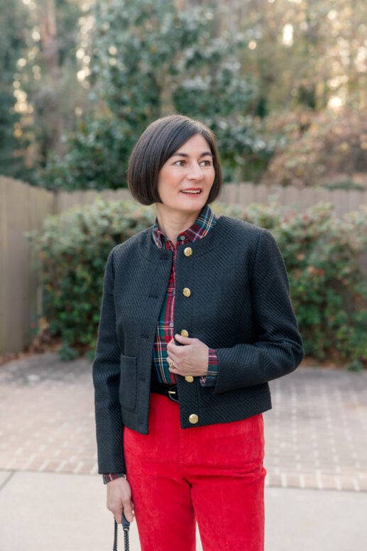 Kelly wearing red J.Crew Vintage Flare corduroy pants with plaid shirt, black tweed jacket, and black boots for petite holiday outfit styling