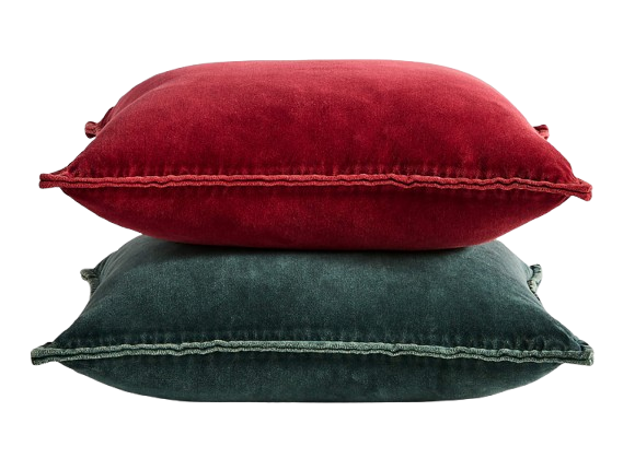 Stack of two velvet pillow covers, one in deep red and one in dark green, both with soft texture and subtle stitched edging.