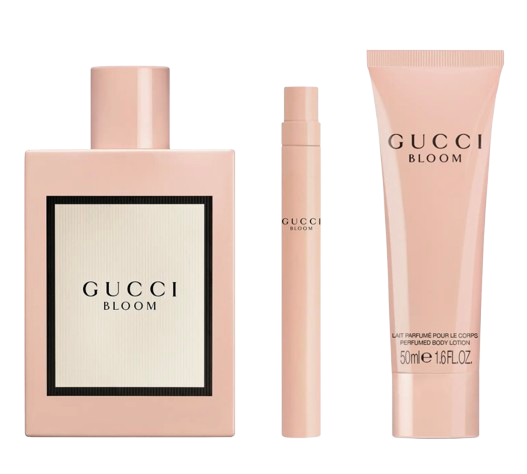 Gucci Bloom Eau de Parfum gift set featuring a blush-pink perfume bottle, a matching travel spray, and a scented body lotion, all in the signature Gucci Bloom floral fragrance.