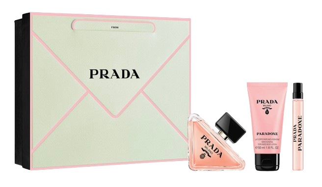 Prada Paradoxe Gift Set featuring a mint-green envelope-style box, a full-size triangular perfume bottle, a pink scented body lotion, and a matching travel spray in the signature Paradoxe fragrance.