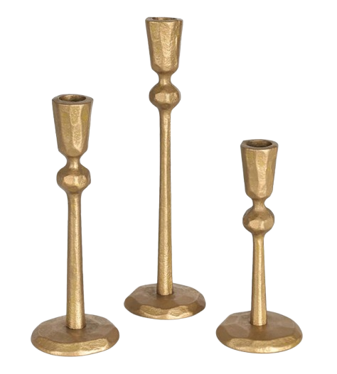 Set of three hammered brass candlestick holders in varying heights, featuring a warm gold finish and sculptural, minimalist design.