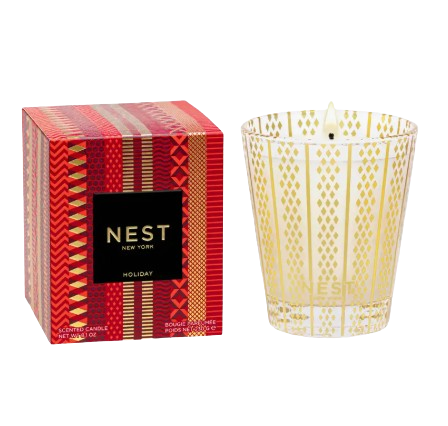 Nest Fragrances Holiday scented candle in an etched gold glass vessel, shown with festive red and gold packaging, featuring notes of pomegranate, mandarin orange, pine, cloves, and cinnamon.