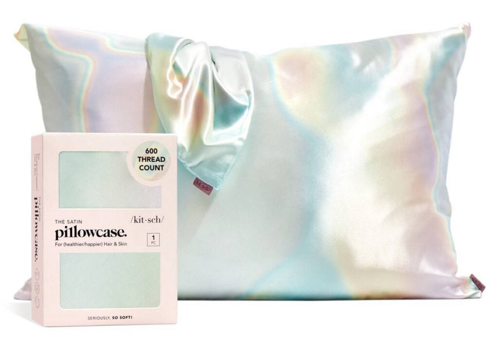 Kitsch satin pillowcase in aura shade with iridescent pearl finish showing product packaging and pillow