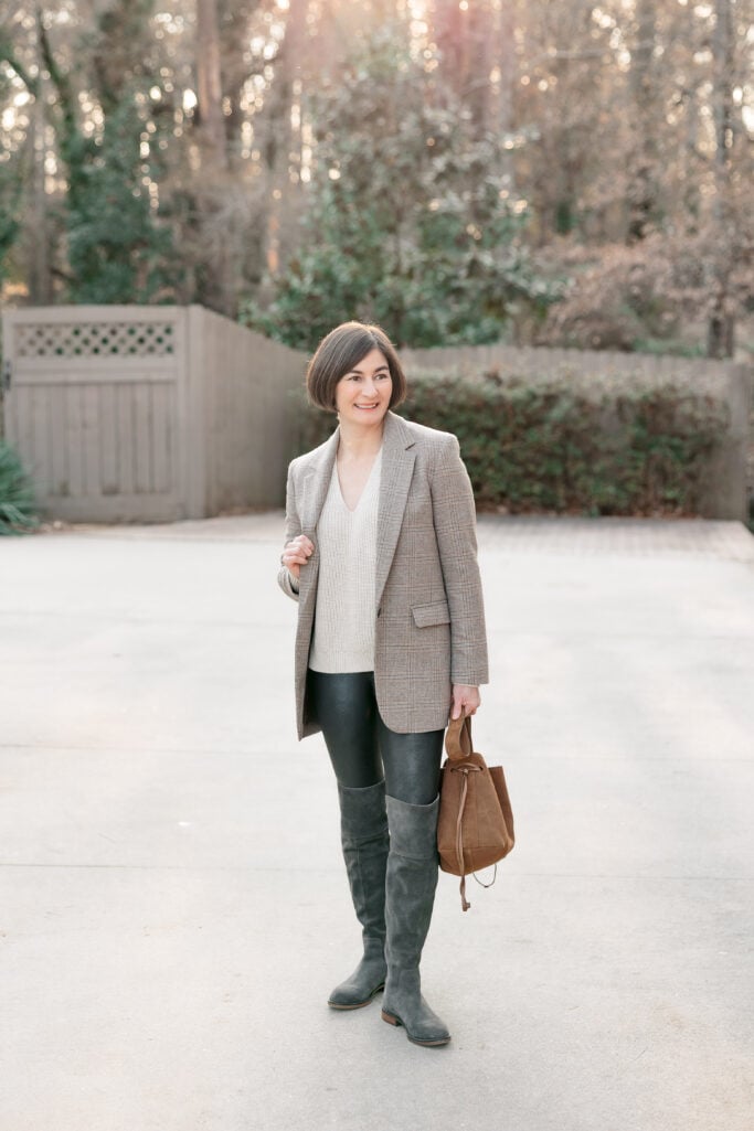 Kelly in full-length petite going out look featuring plaid blazer, cream sweater, Spanx faux leather leggings, grey suede tall boots and tan suede drawstring bag