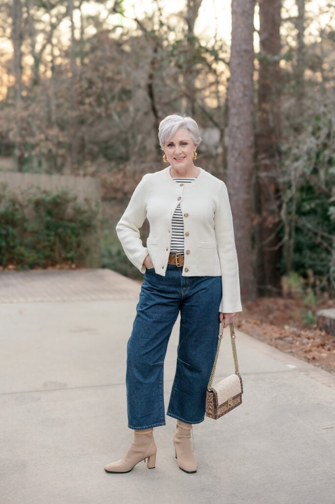 Barrel jeans with curved silhouette styled with striped tee, cropped cardigan and ankle boots